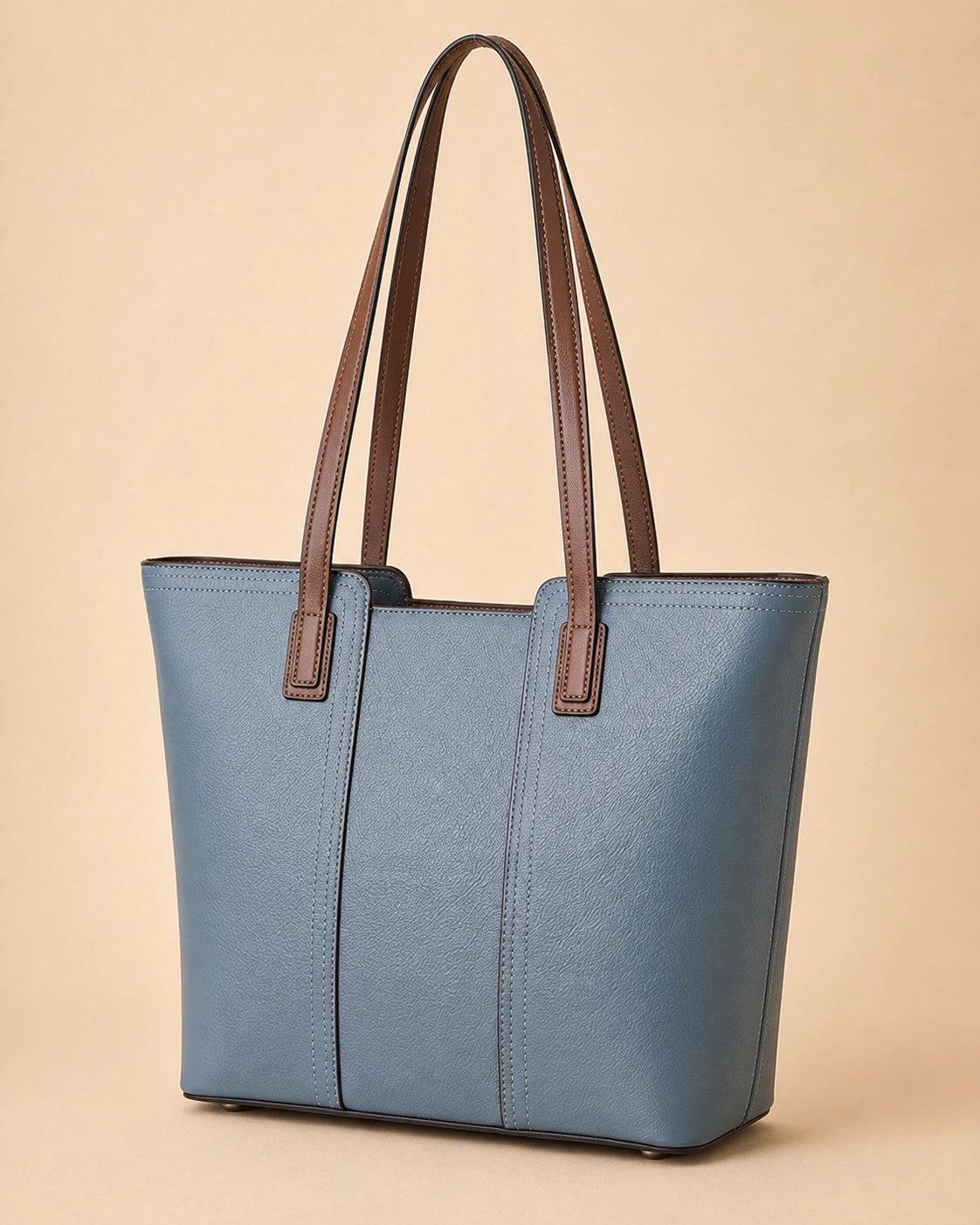 Close-up of the Sienna genuine leather tote bag showing the shoulder strap attachment.