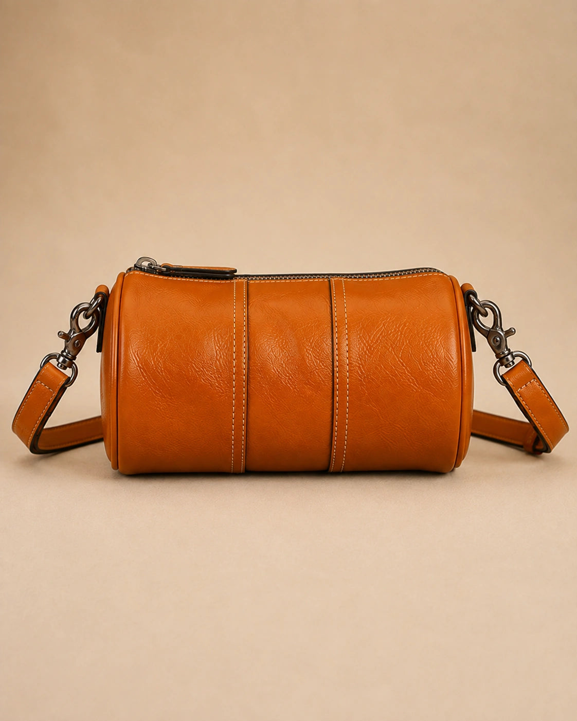 Interior view of the Romy genuine leather barrel bag showing the zip pocket and phone pocket.