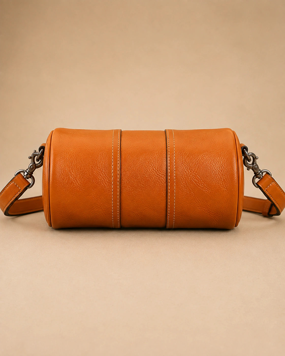 The Romy genuine leather barrel bag worn crossbody for everyday use.