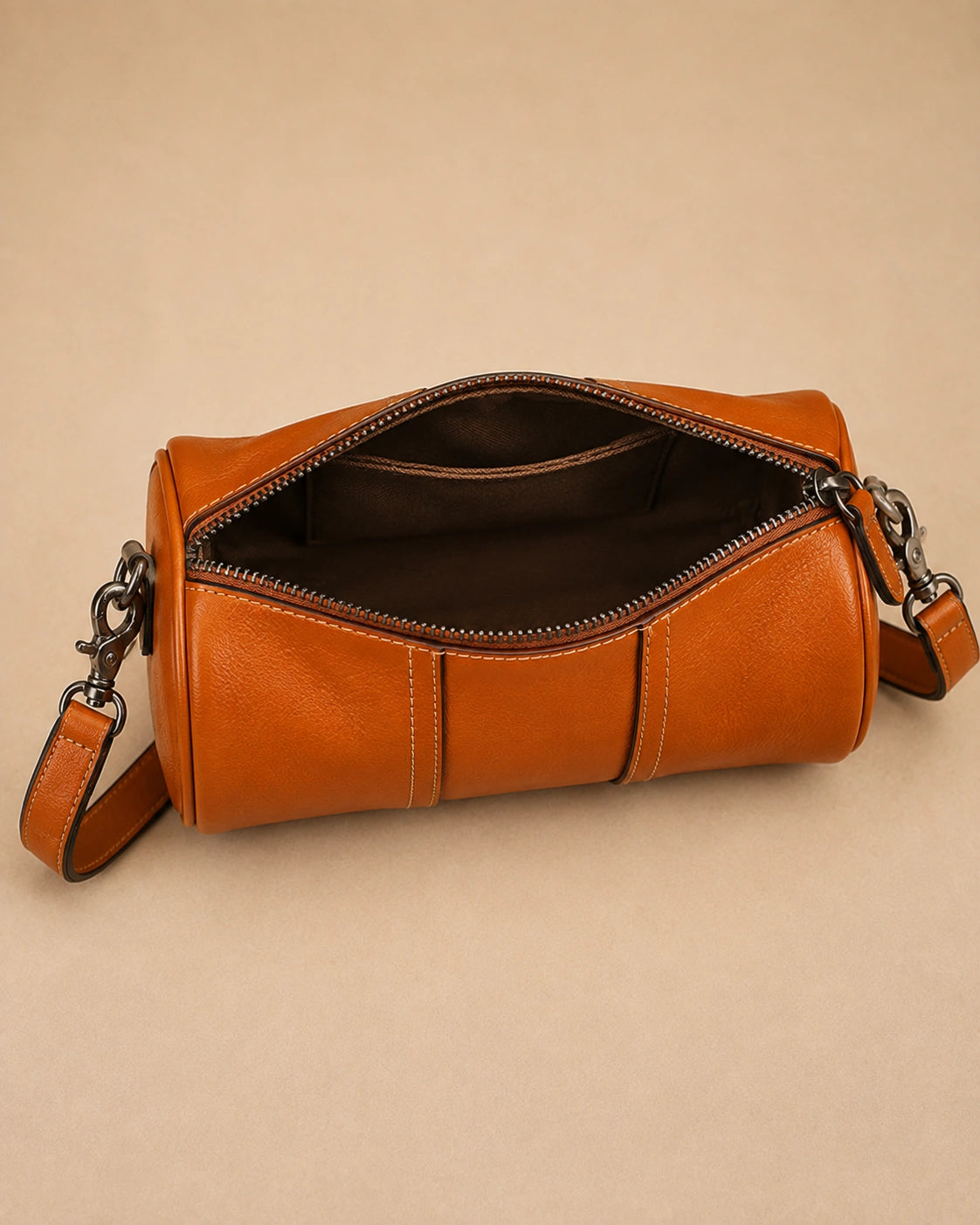 The Romy genuine leather barrel bag worn over the shoulder.