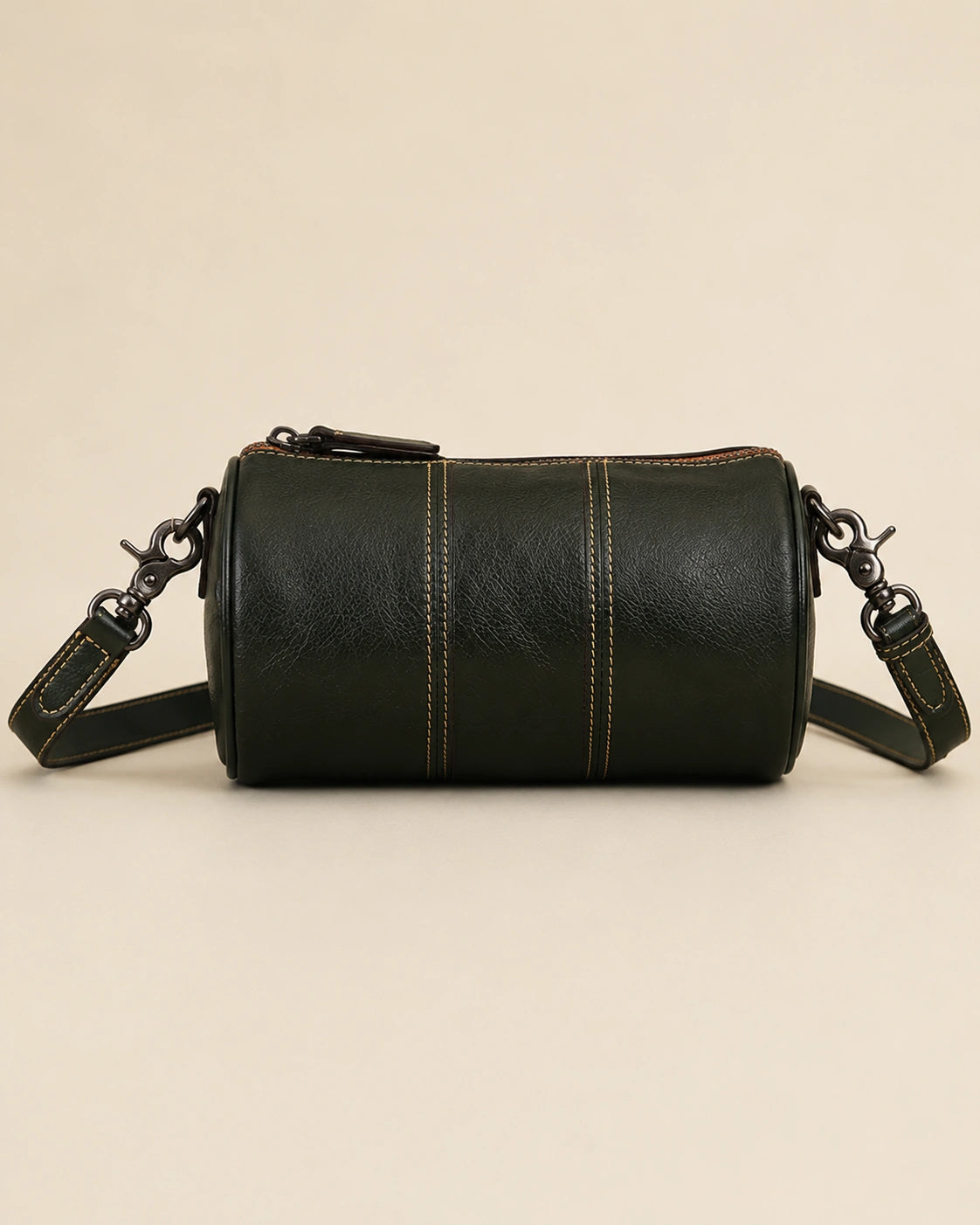 Front view of the Romy genuine leather barrel bag showing the rounded barrel shape.
