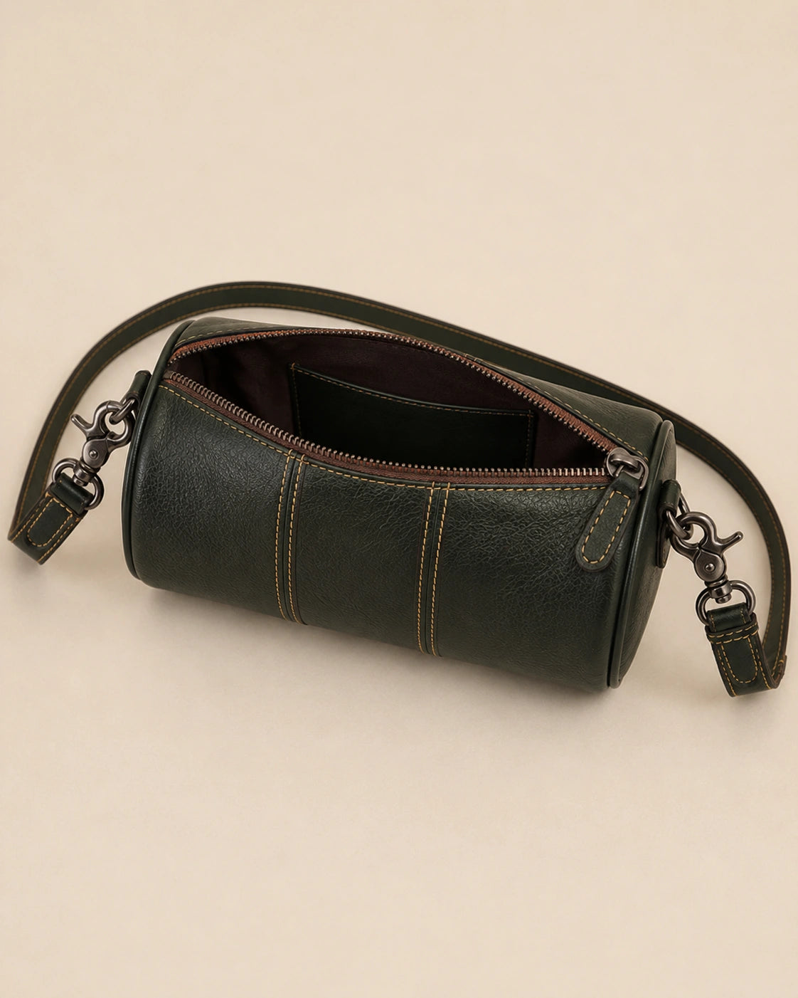 Detail view of the Romy genuine leather barrel bag showing the zip closure.