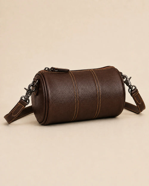 The Romy genuine leather barrel bag shown from a lifestyle angle.