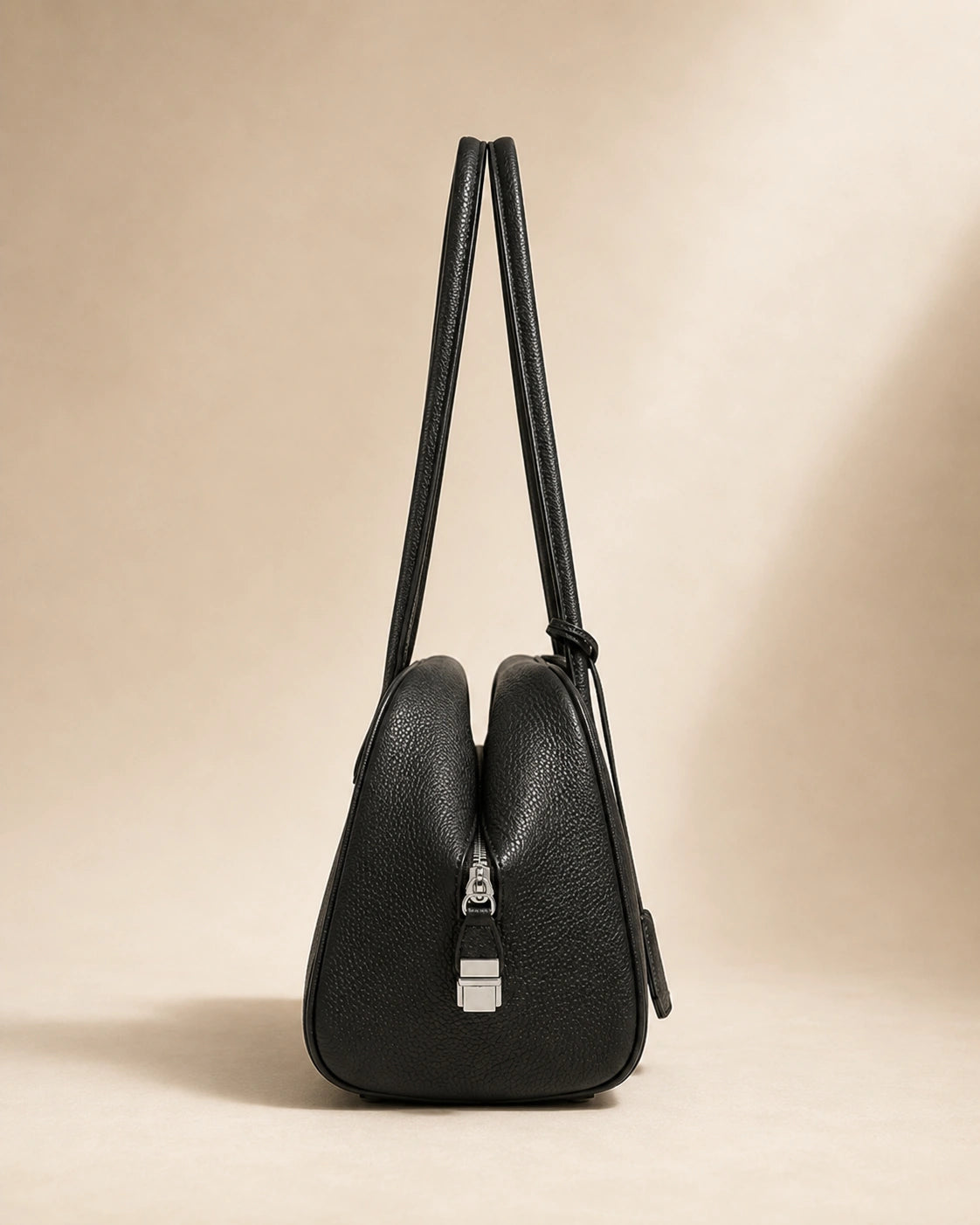 Detail view of the Wren leather hobo bag's stitching and hardware.