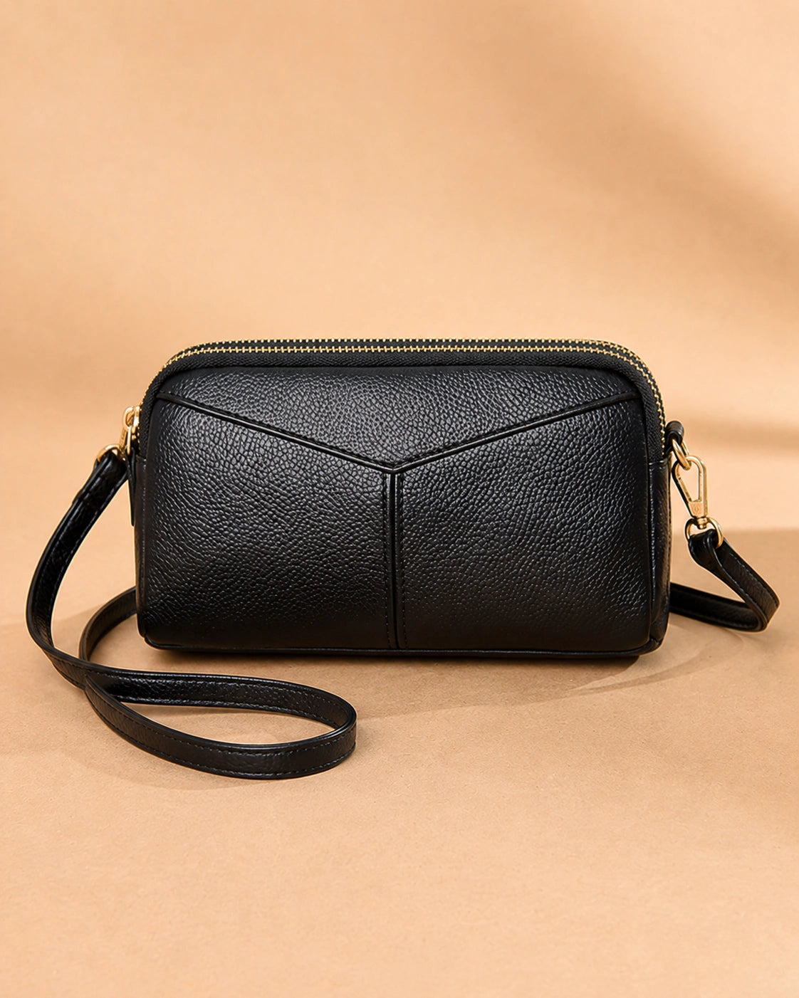 Front view of the Etta small genuine leather crossbody bag showing the horizontal-square silhouette.