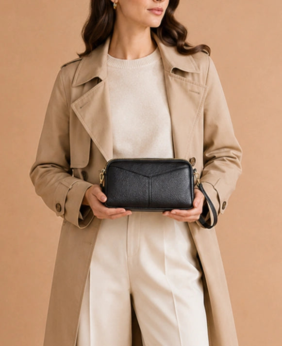 Interior view of the Etta leather crossbody bag showing the zip pocket and patch pocket.