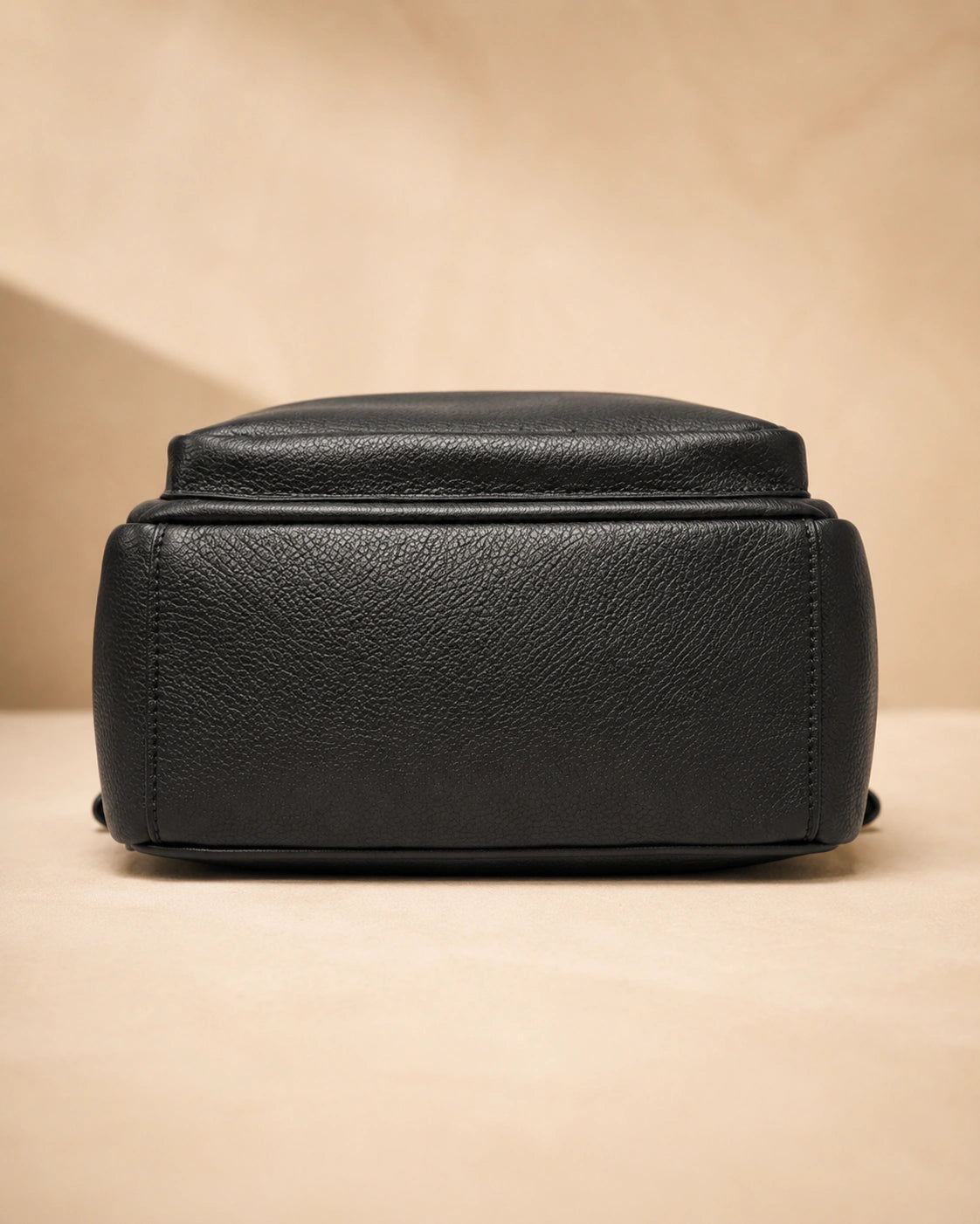 Base view of the Isla lightweight genuine leather travel backpack in black