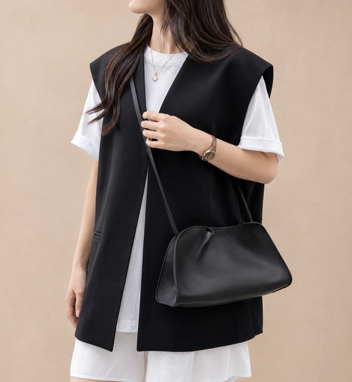 Woman wearing the Corinne genuine leather commuter handbag in black crossbody with the long shoulder strap
