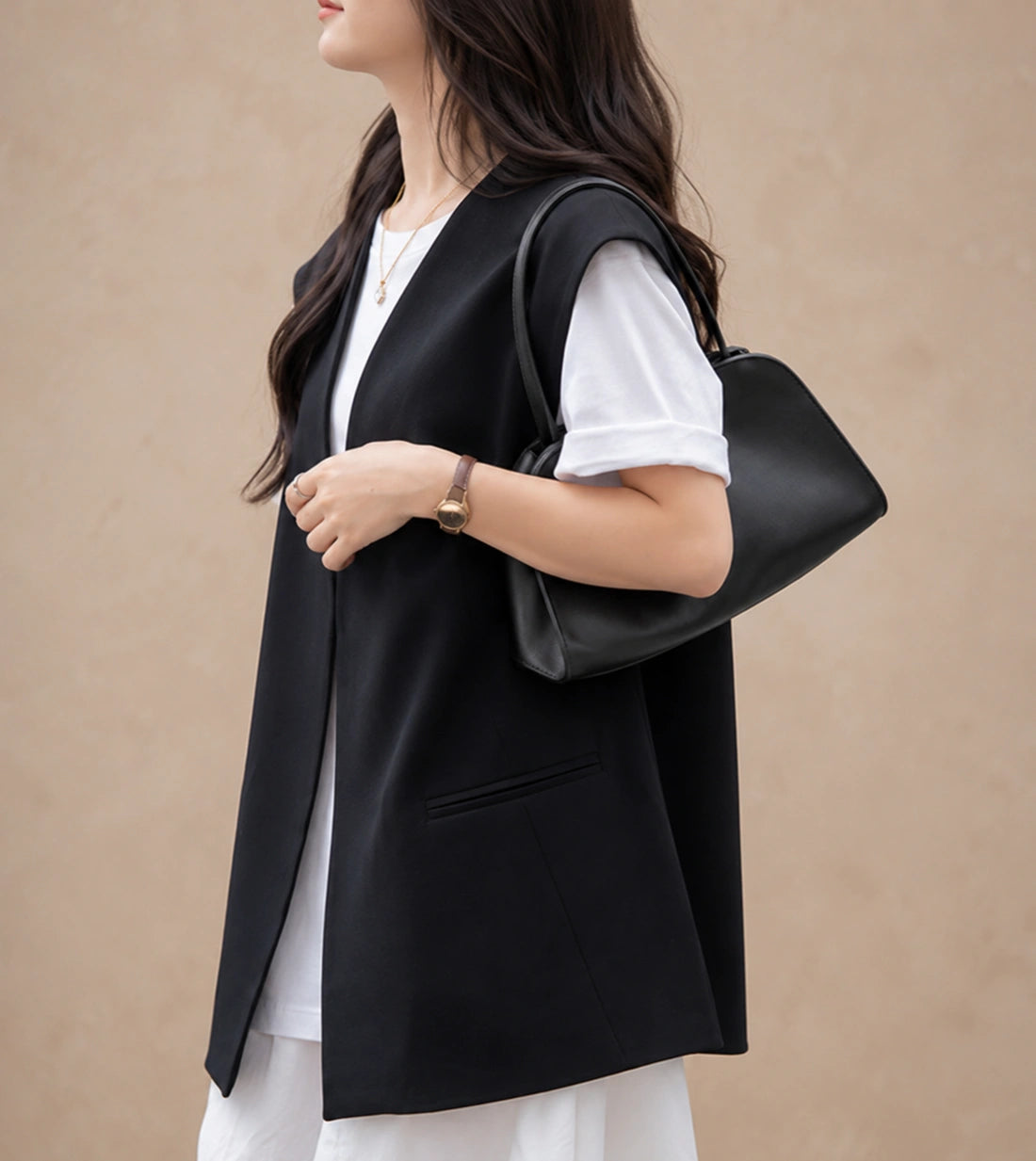 Woman wearing the Corinne genuine leather commuter handbag in black on the shoulder