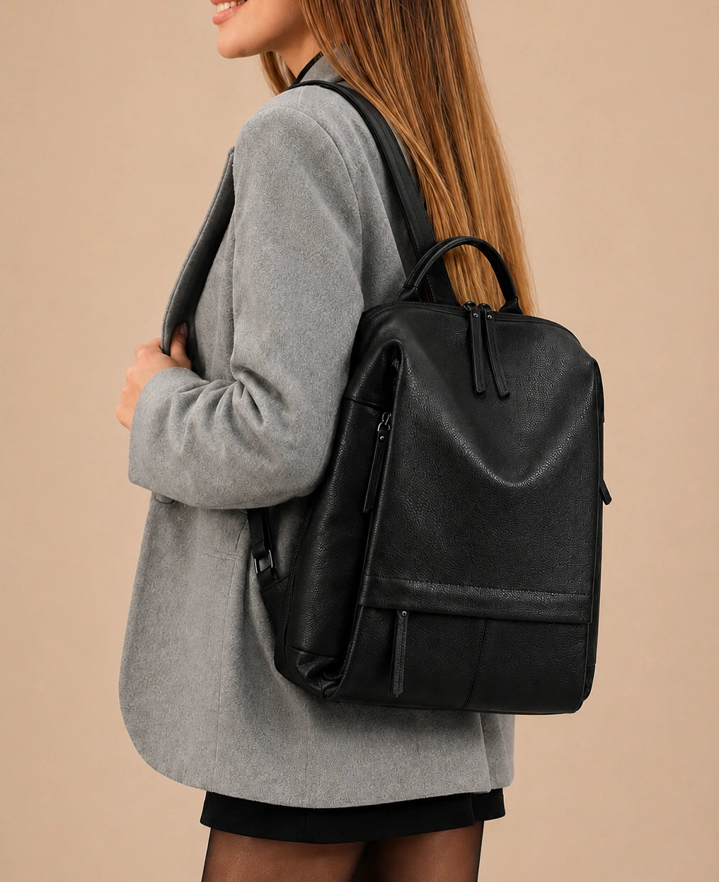 Woman wearing the Cecily genuine leather backpack with laptop pocket in black, full-length lifestyle view