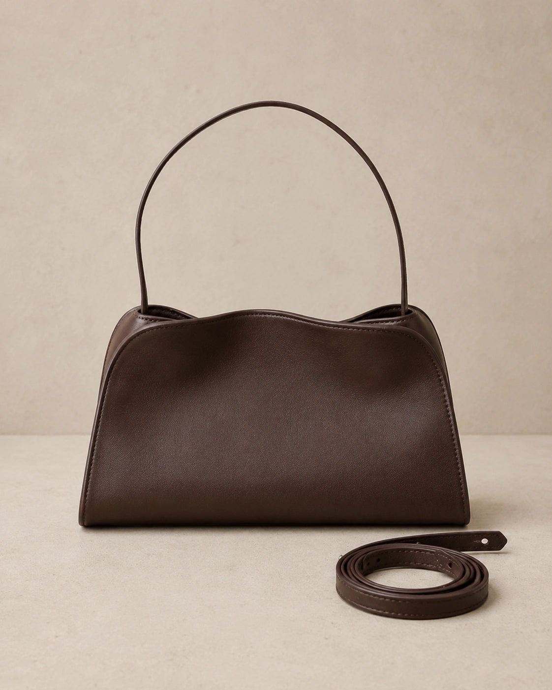 Front view of the Corinne genuine leather commuter handbag in coffee with the shoulder strap detached