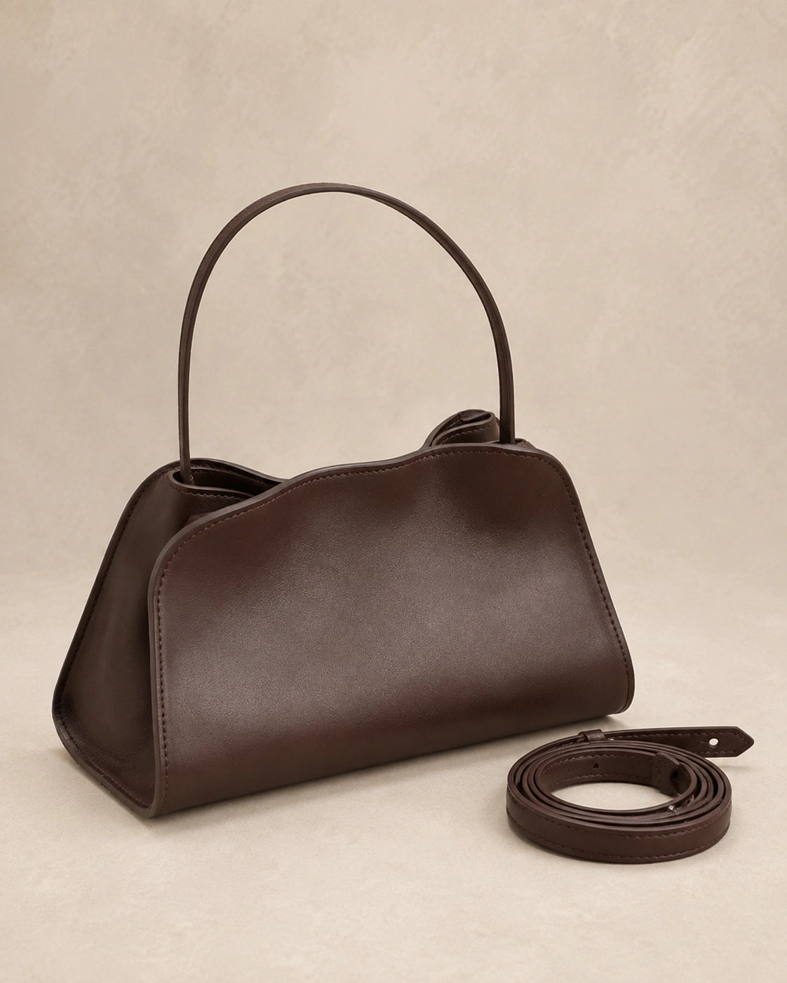 Front view of the Corinne genuine leather commuter handbag in coffee showing the top handle