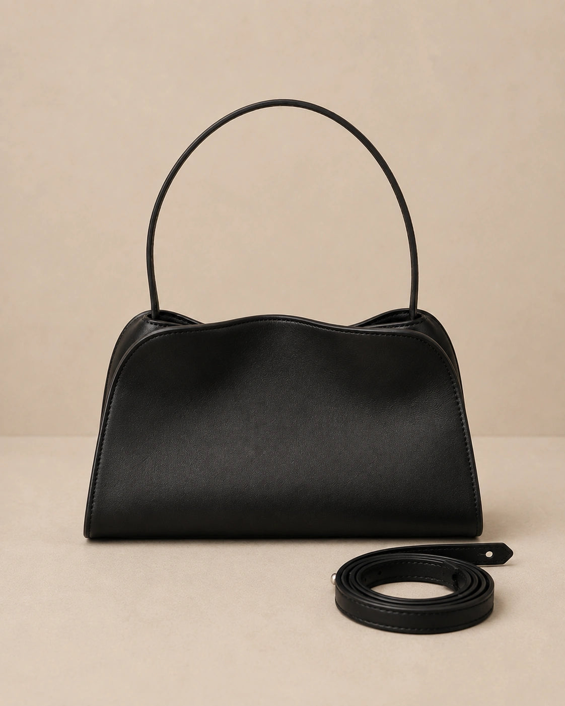Front view of the Corinne genuine leather commuter handbag in black showing the top handle