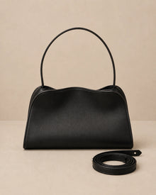 Front view of the Corinne genuine leather commuter handbag in black showing the top handle