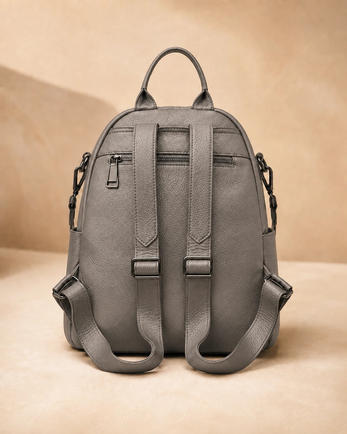 Back view of the Isla lightweight genuine leather travel backpack in grey showing the adjustable straps