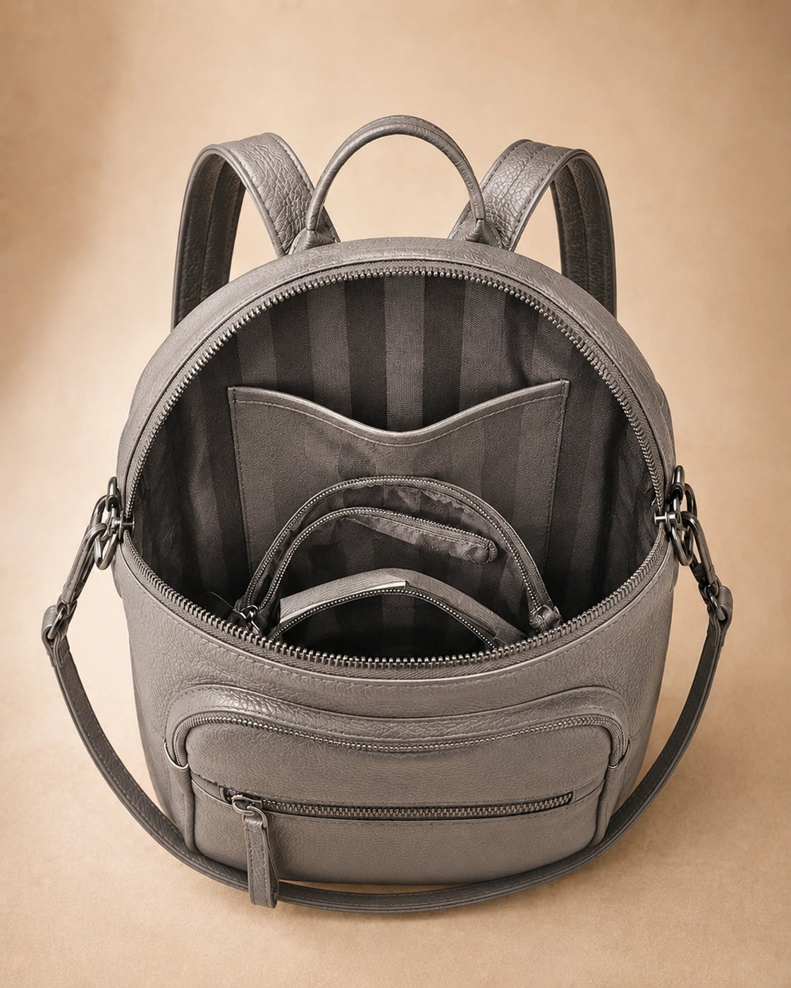 Interior view of the Isla lightweight genuine leather travel backpack in grey showing the lined compartment