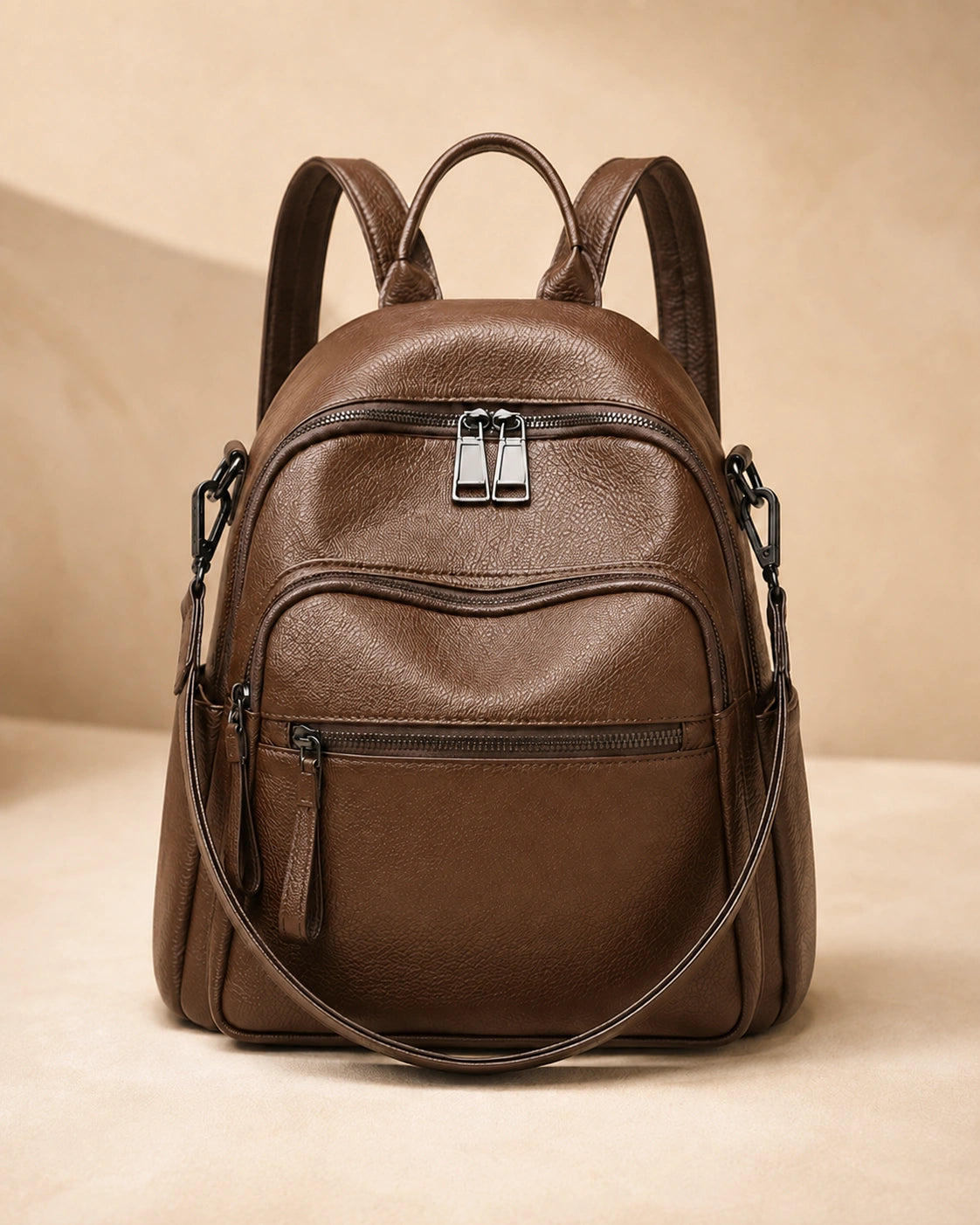 Front view of the Isla lightweight genuine leather travel backpack in brown