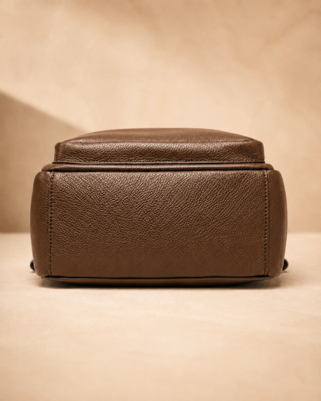 Base view of the Isla lightweight genuine leather travel backpack in brown