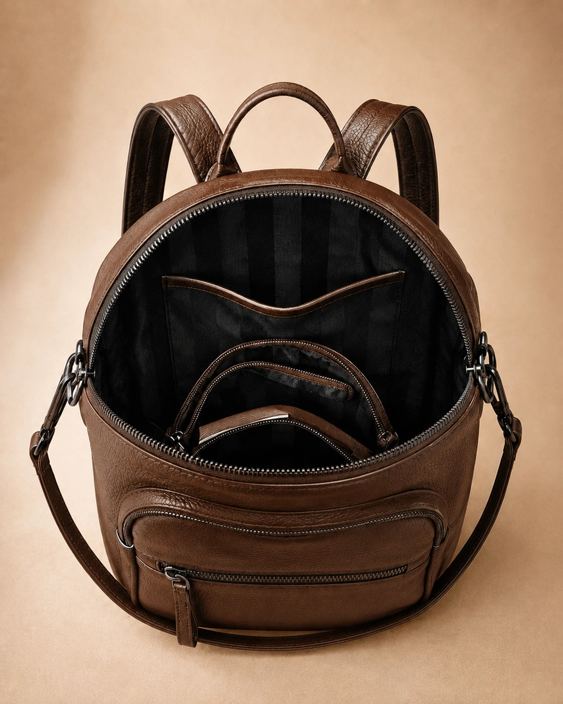 Interior view of the Isla lightweight genuine leather travel backpack in brown showing the lined compartment