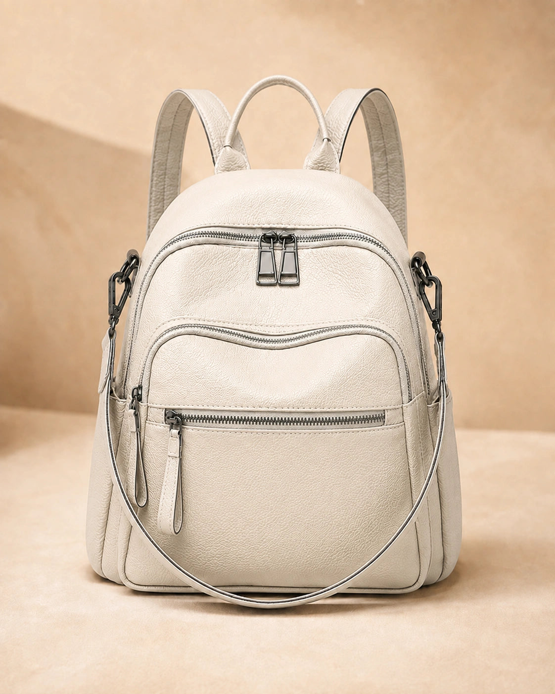Front view of the Isla lightweight genuine leather travel backpack in off-white