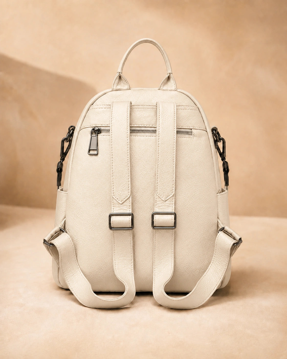 Back view of the Isla lightweight genuine leather travel backpack in off-white showing the adjustable straps