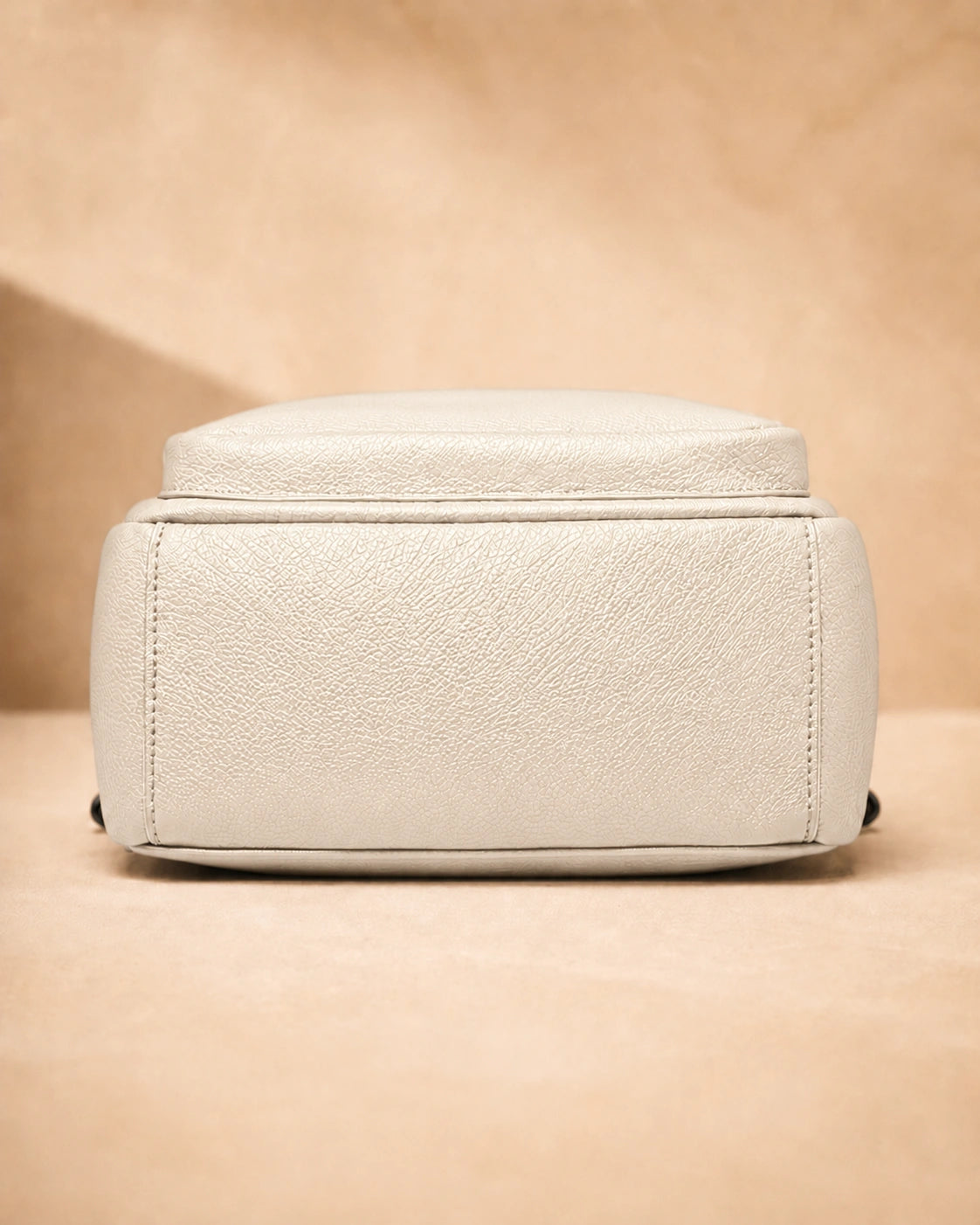 Base view of the Isla lightweight genuine leather travel backpack in off-white