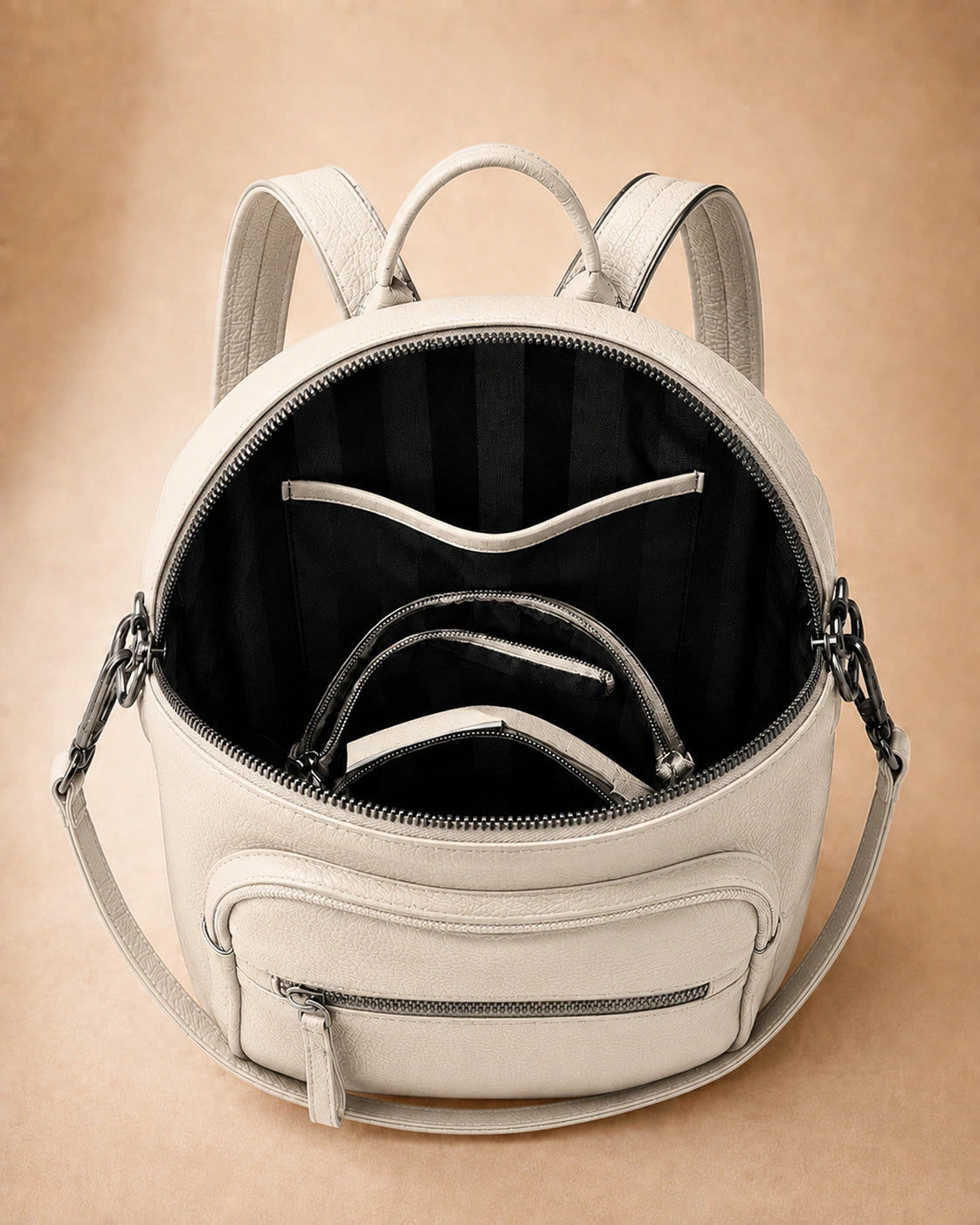 Interior view of the Isla lightweight genuine leather travel backpack in off-white showing the lined compartment