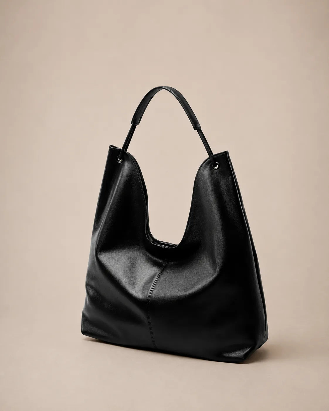 Angled front view of the Colette black leather hobo tote bag featuring a soft silhouette, spacious design and minimalist everyday elegance.