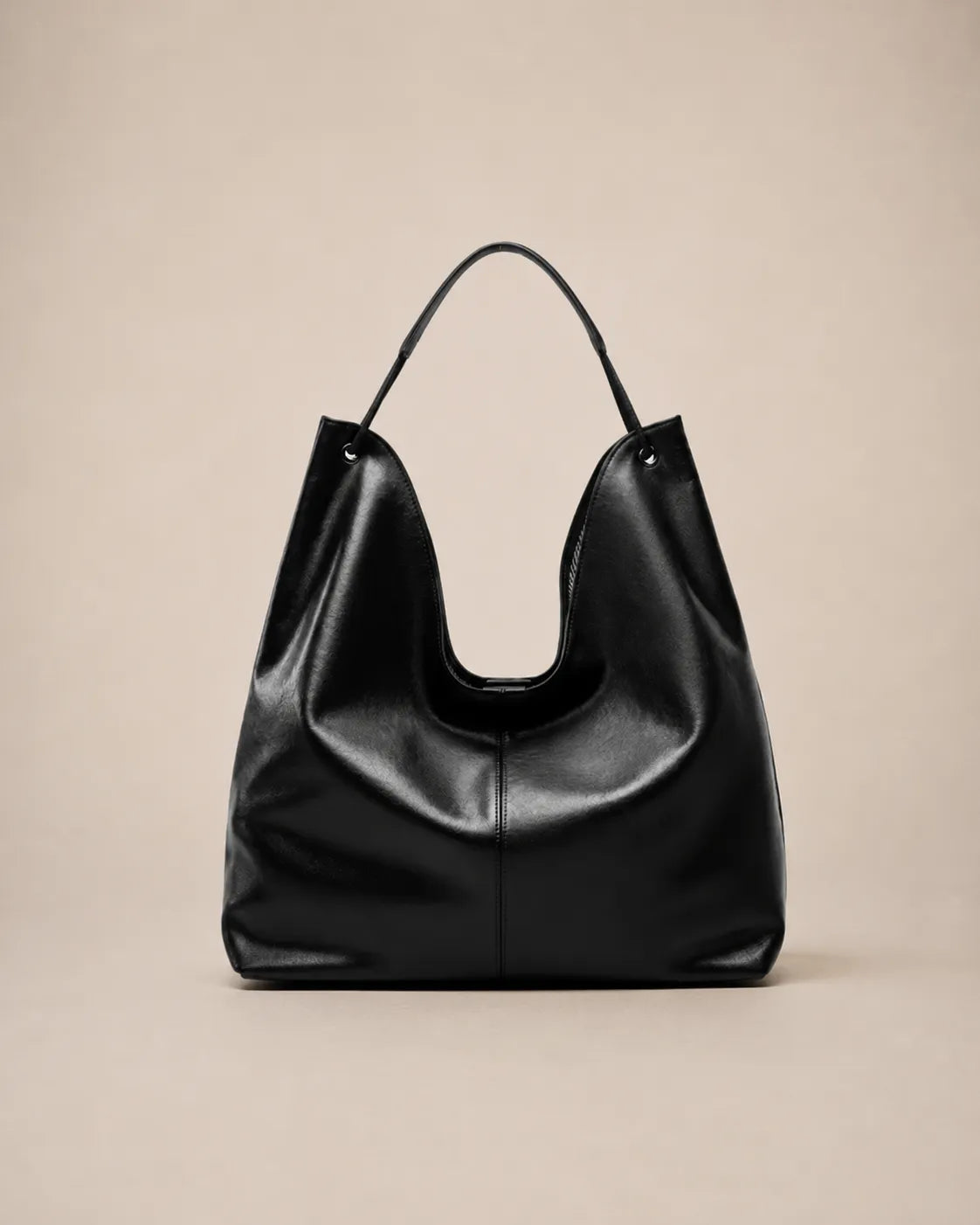 Front view of the Colette black leather hobo tote bag showcasing its relaxed shape, soft structure and spacious interior capacity.