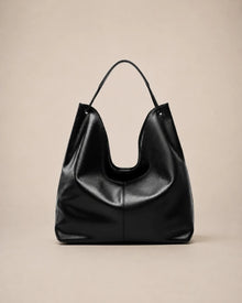 Front view of the Colette black leather hobo tote bag showcasing its relaxed shape, soft structure and spacious interior capacity.