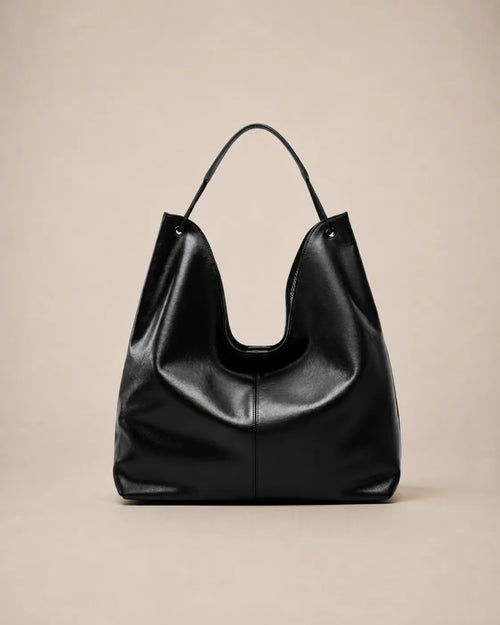 Front view of the Colette black leather hobo tote bag showcasing its relaxed shape, soft structure and spacious interior capacity.