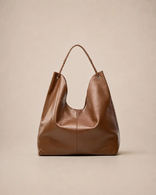 Front view of the Colette leather hobo tote bag in brown featuring a soft silhouette and spacious interior for everyday use.