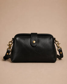 Eloise leather crossbody bag in black genuine leather with structured silhouette and antique gold-tone hardware, front view.
