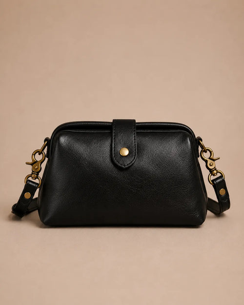 Eloise leather crossbody bag in black genuine leather with structured silhouette and antique gold-tone hardware, front view.