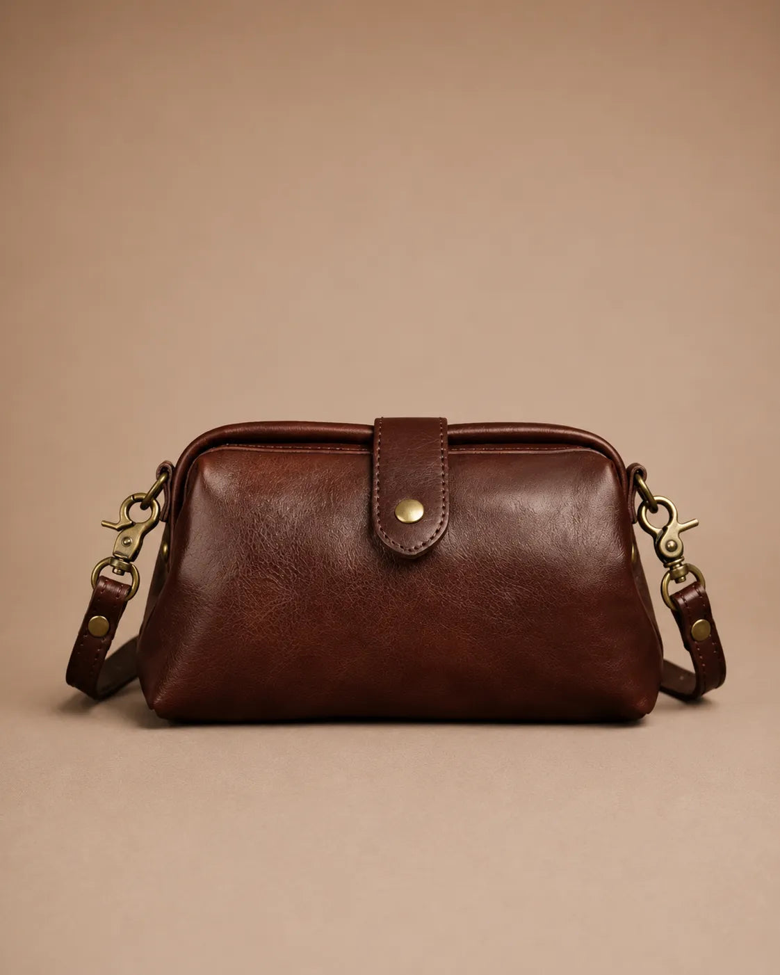 Front view of the Eloise leather crossbody bag in dark chocolate genuine leather with vintage-inspired brass hardware.