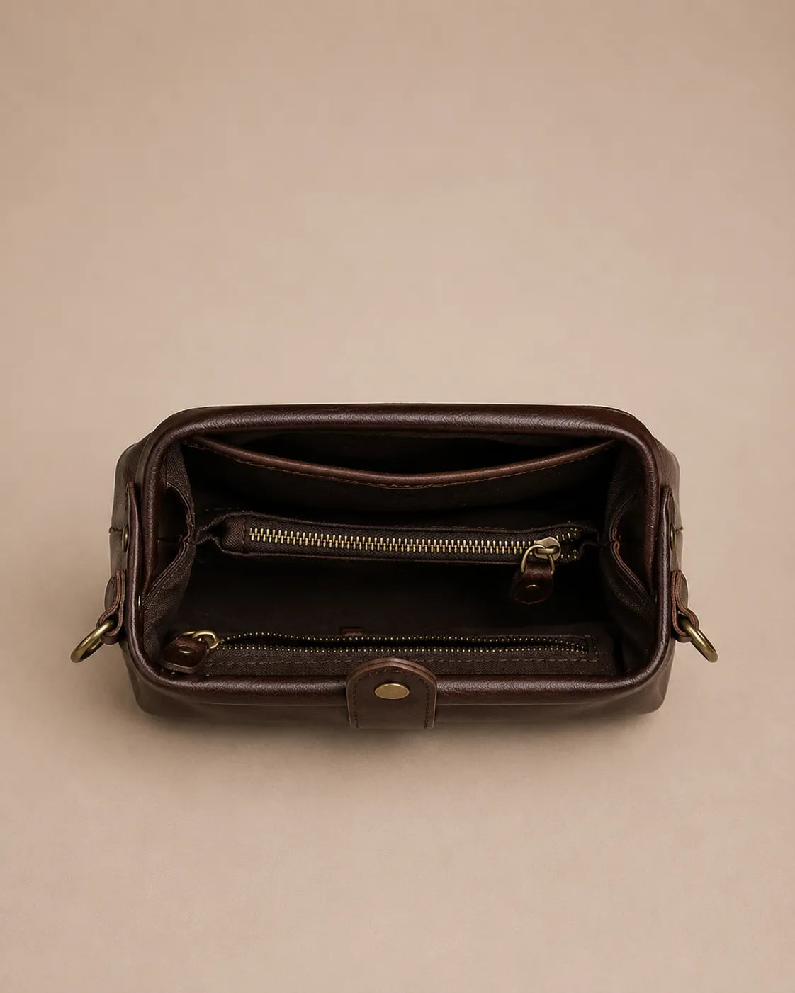 Interior view of the Eloise leather crossbody bag in dark chocolate genuine leather featuring multiple compartments and zip pockets.