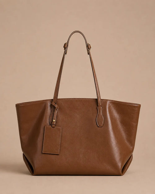 Emilia Tote in brown genuine leather featuring a soft structured silhouette, adjustable shoulder straps and spacious everyday design.