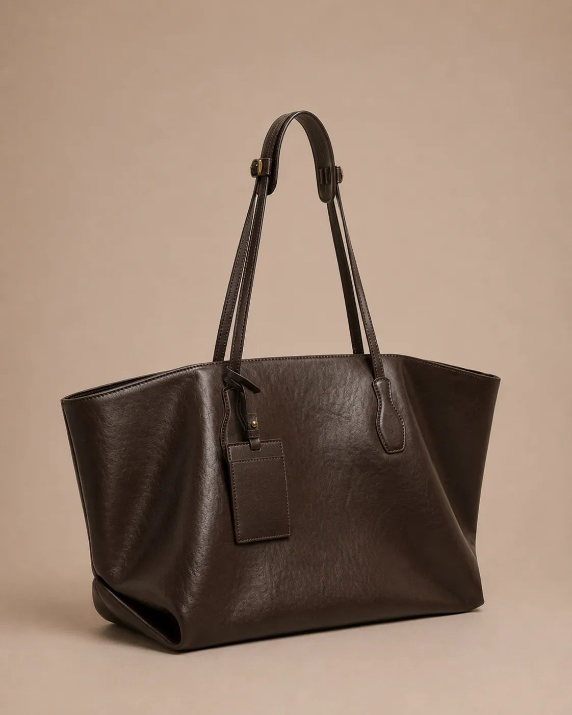 Angled view of the Emilia Tote in dark chocolate leather, highlighting its soft silhouette, spacious interior and refined craftsmanship.