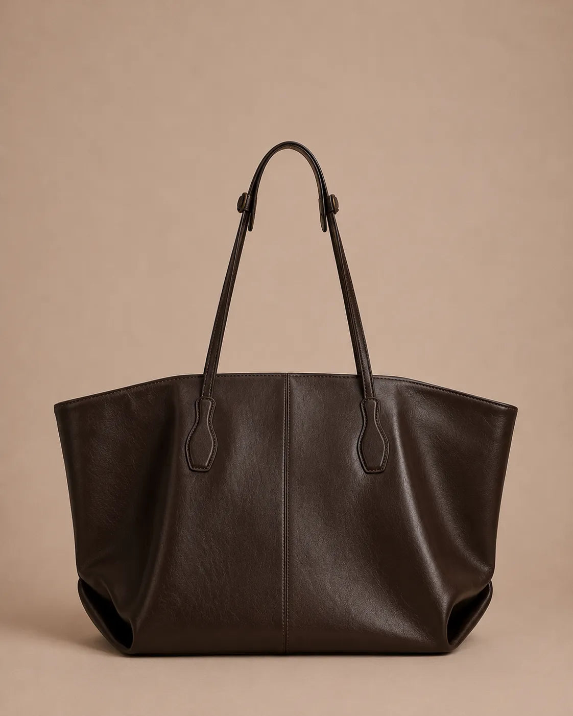 Back view of the Emilia Tote in dark chocolate leather, showcasing the clean lines, soft structure and minimalist design.