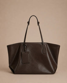 Front view of the Emilia Tote in dark chocolate leather, featuring a spacious silhouette, adjustable shoulder straps and elegant everyday design.
