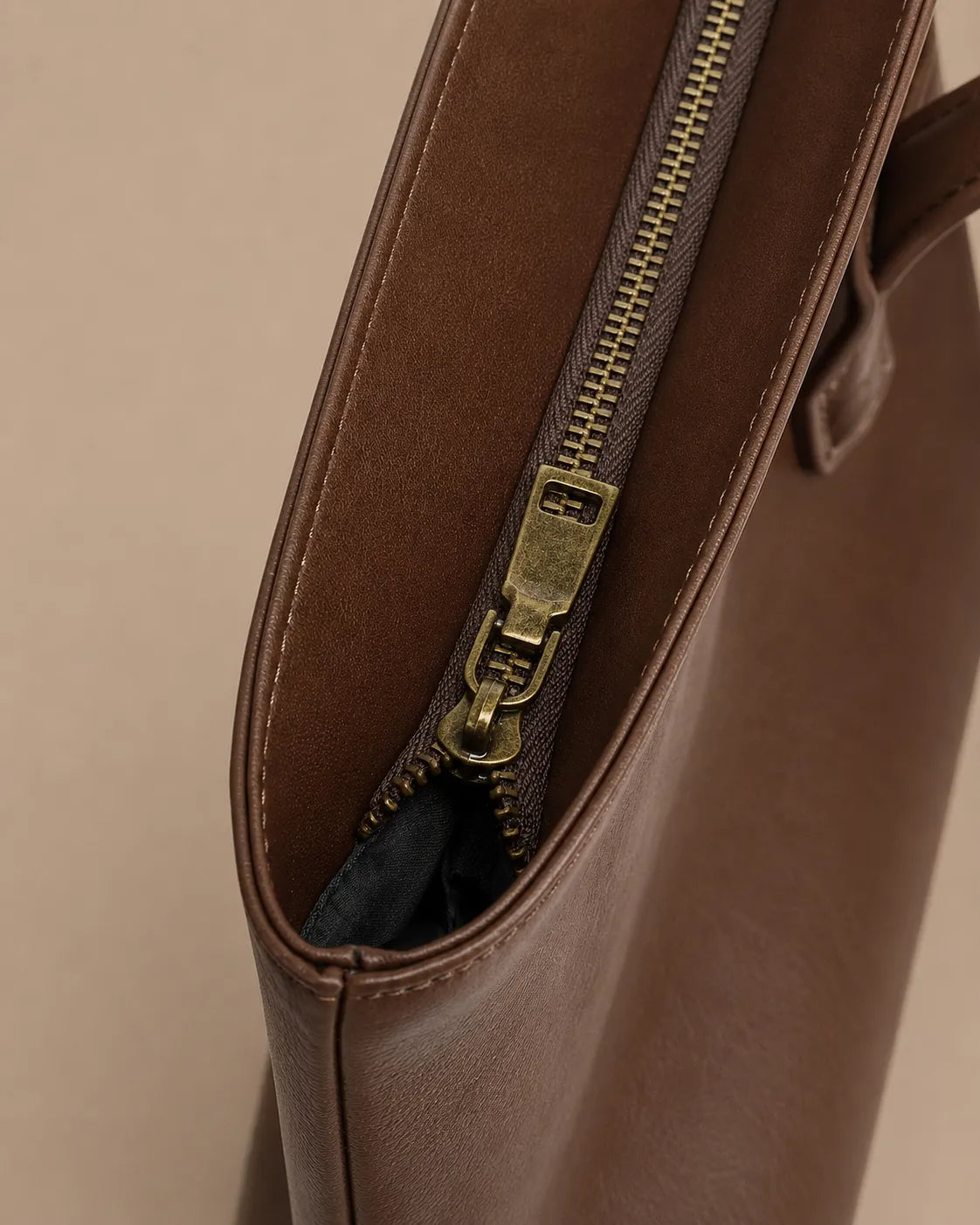 Close-up of the Emilia Tote zip closure, showcasing premium leather trim and secure top zipper fastening.