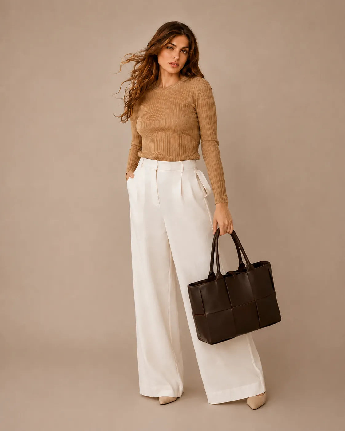 Woman holding the Florence oversized woven leather tote bag in chocolate brown genuine leather.