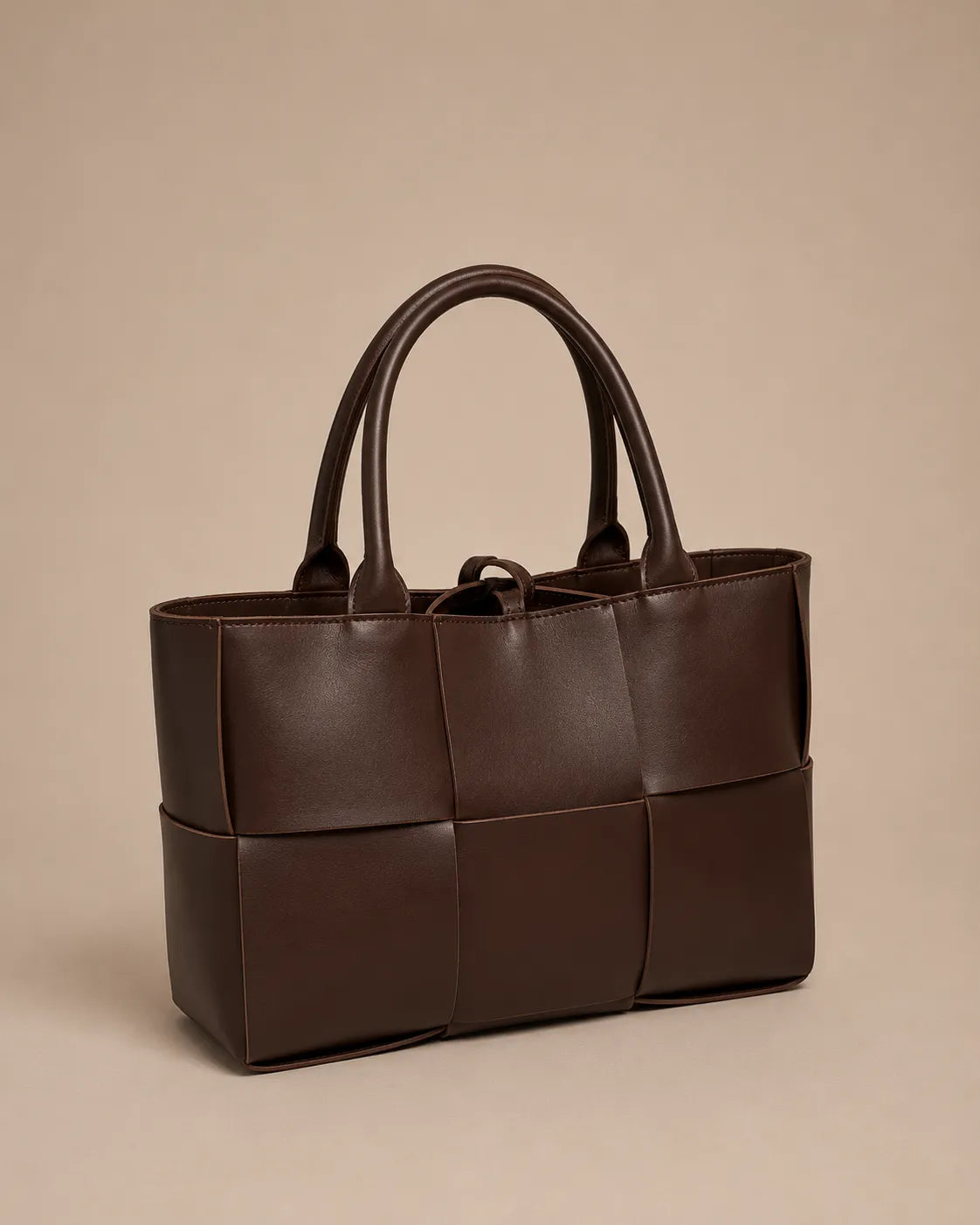 Angled front view of the Florence woven leather tote bag in chocolate brown genuine leather.