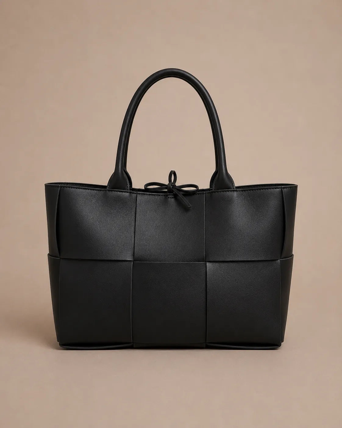 Front view of the Florence woven leather tote bag in black genuine leather.