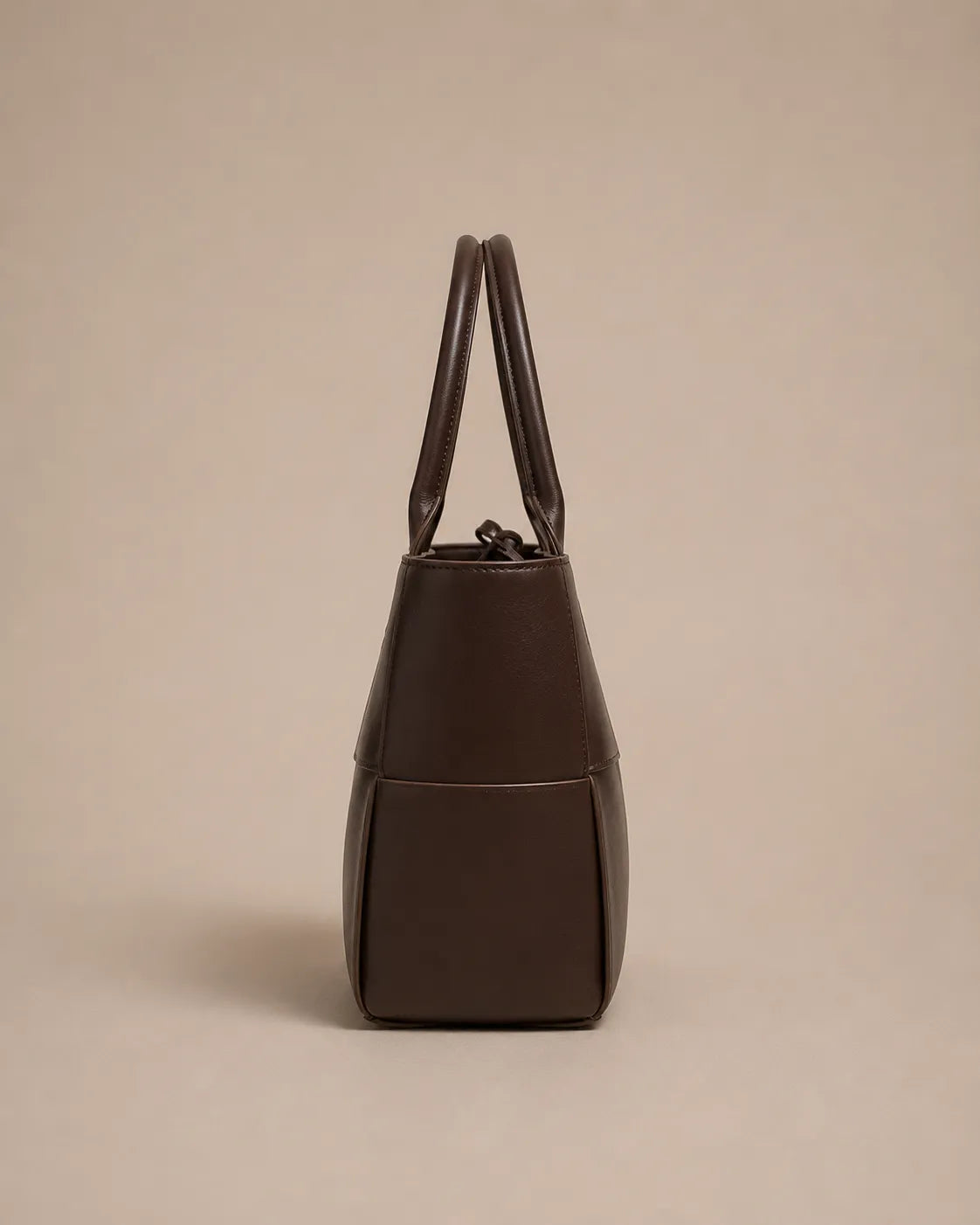 Side view of the Florence woven leather tote bag in genuine chocolate brown leather.
