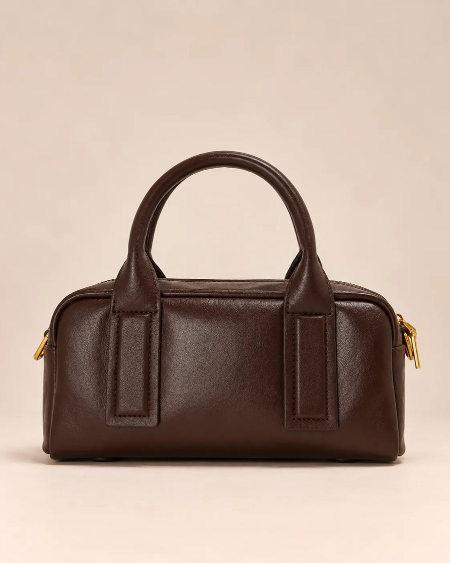 Front view of the Brigitte genuine leather Boston bag in dark chocolate with rounded top handles and gold-tone hardware, by Malena London