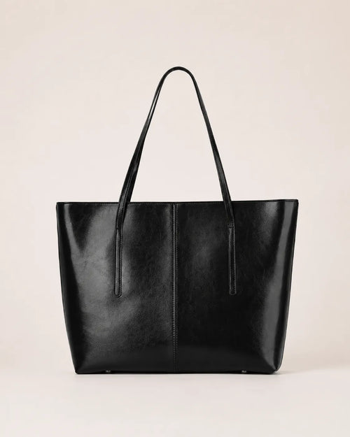 Margaux large black leather tote bag front view with double shoulder straps and spacious structured silhouette