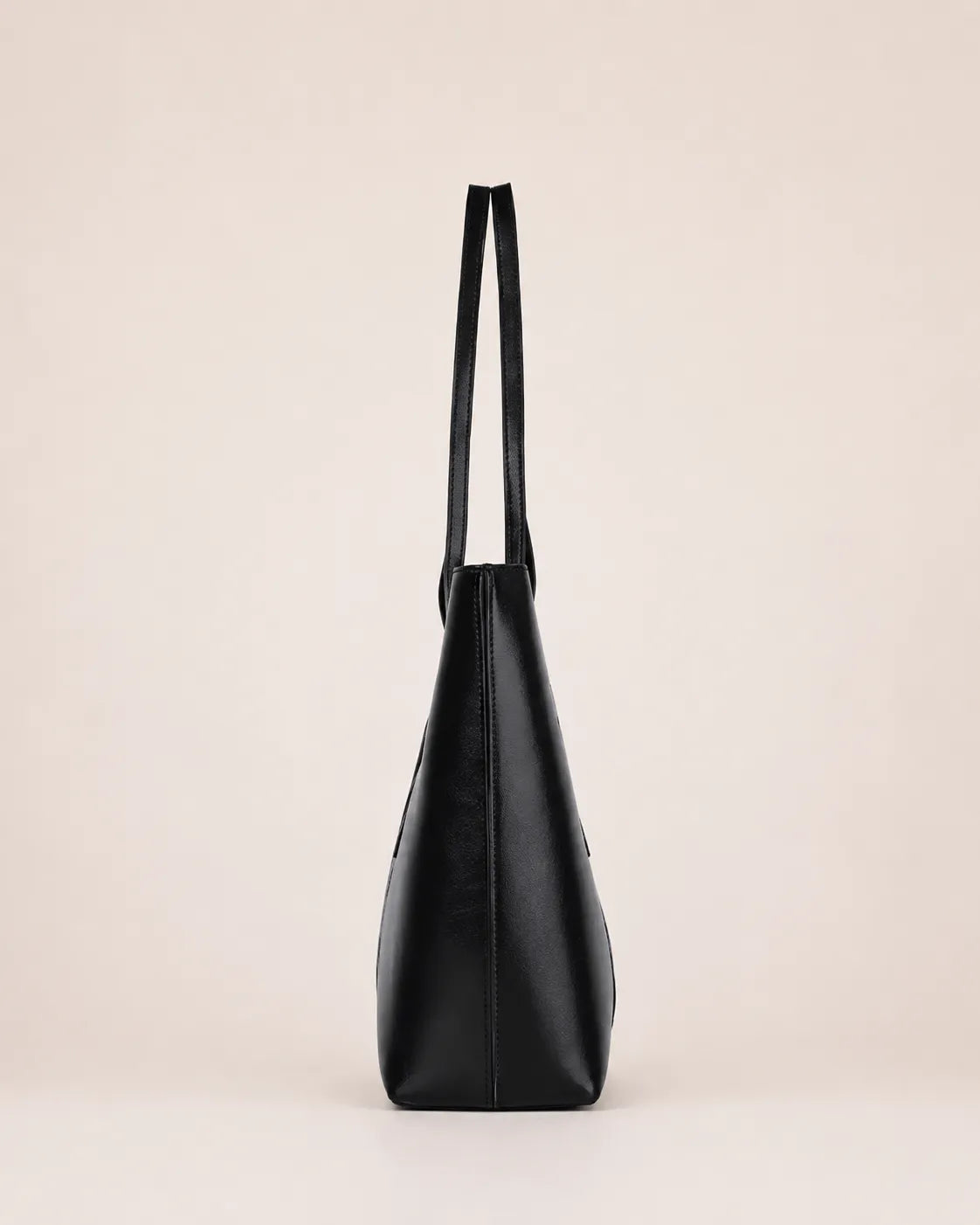 Margaux large black leather tote bag side view showcasing structured silhouette and spacious profile