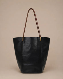 Margot Tote in black genuine leather with a minimalist design, spacious interior and versatile day-to-evening appeal.