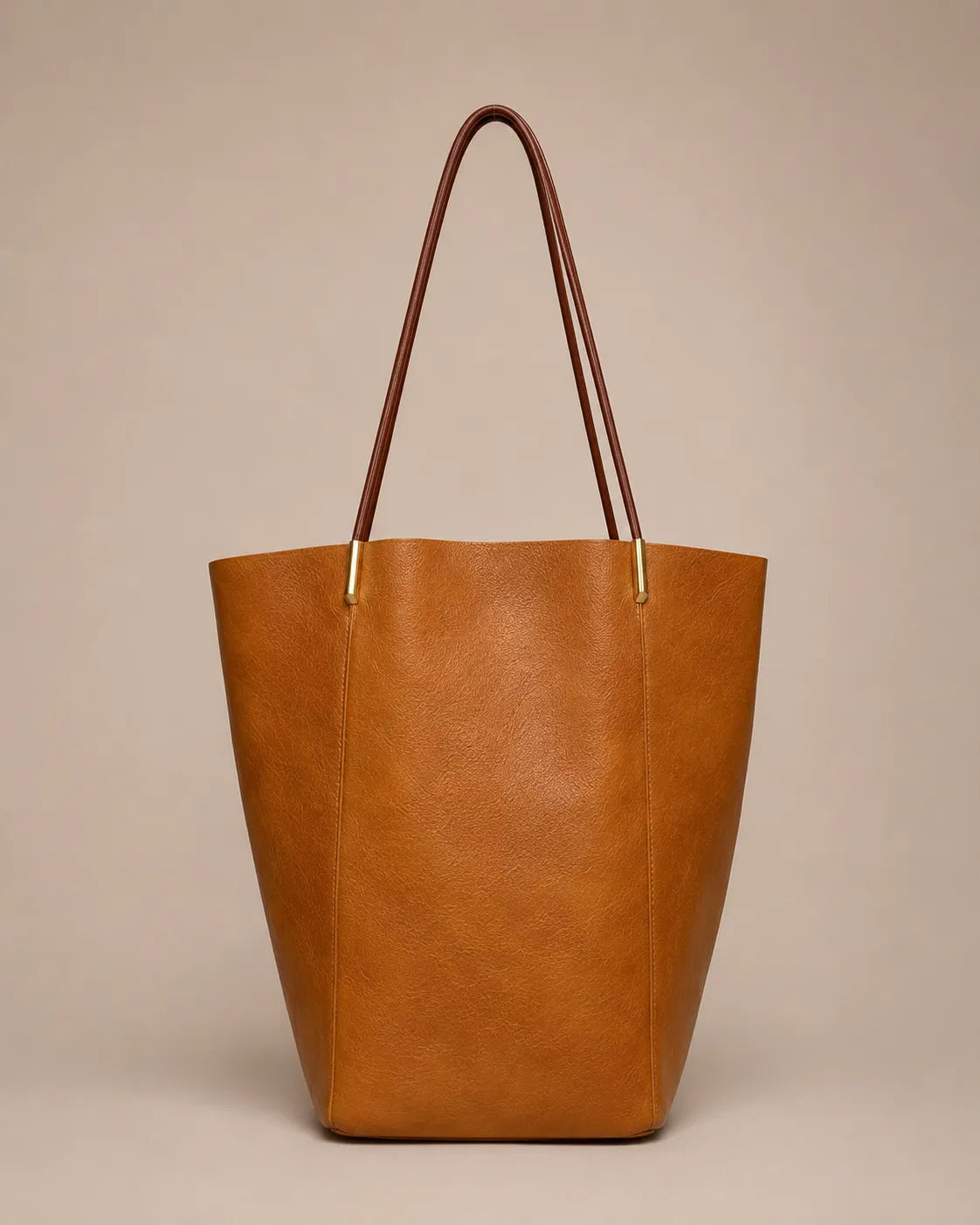 Margot Tote in brown genuine leather featuring a clean vertical silhouette, slim shoulder straps and timeless everyday elegance.